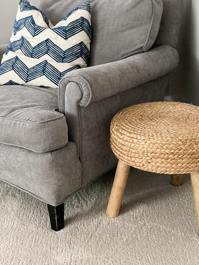 Grey chair with natural woven stool. 